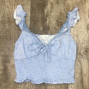 Blue top with ruffle sleeves and bow